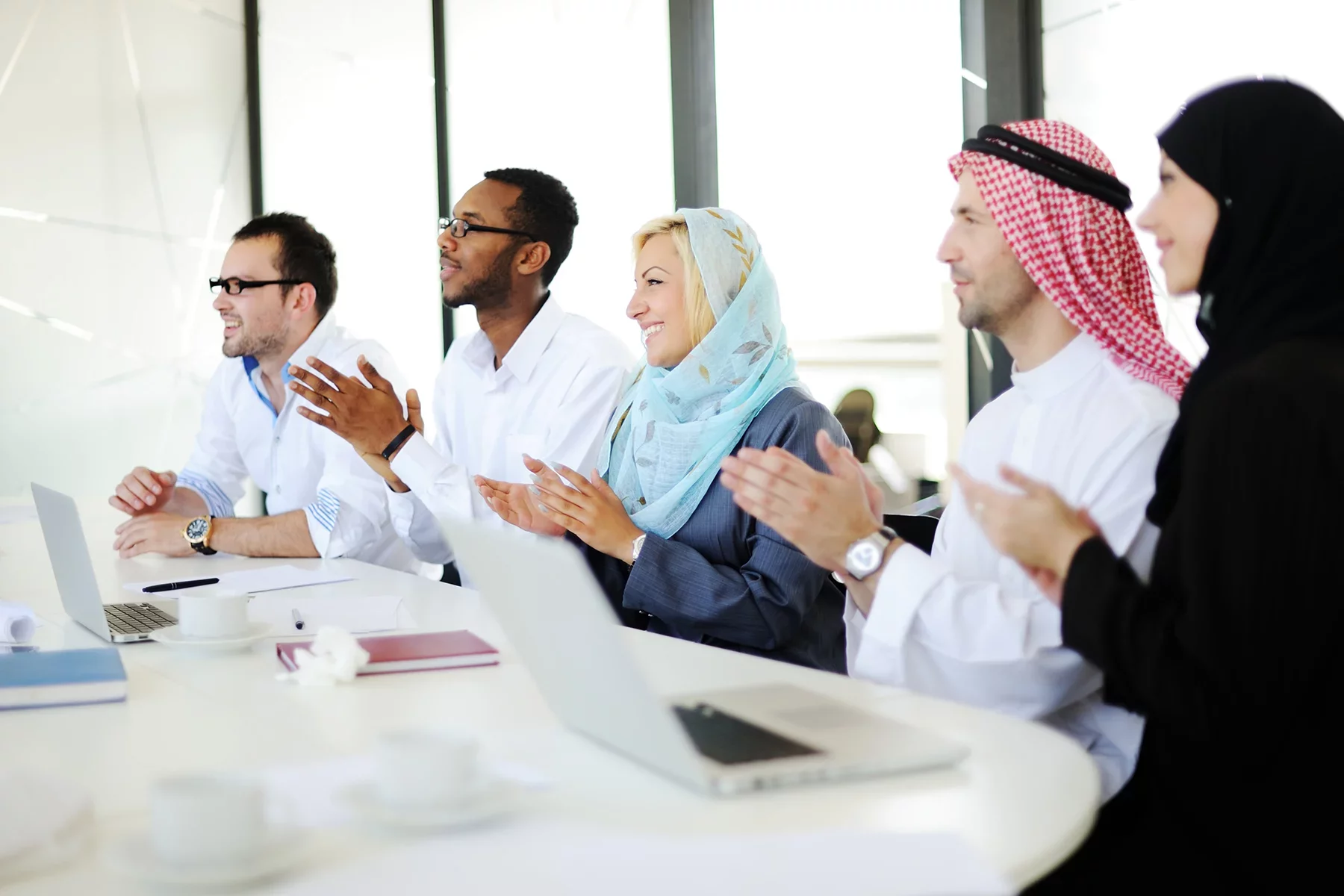 Diverse Middle East business team collaborating in modern office